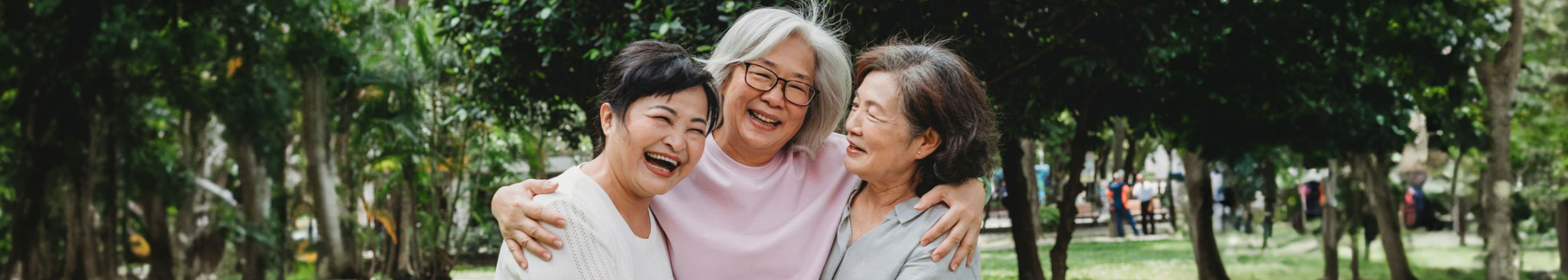 three women hugging happy