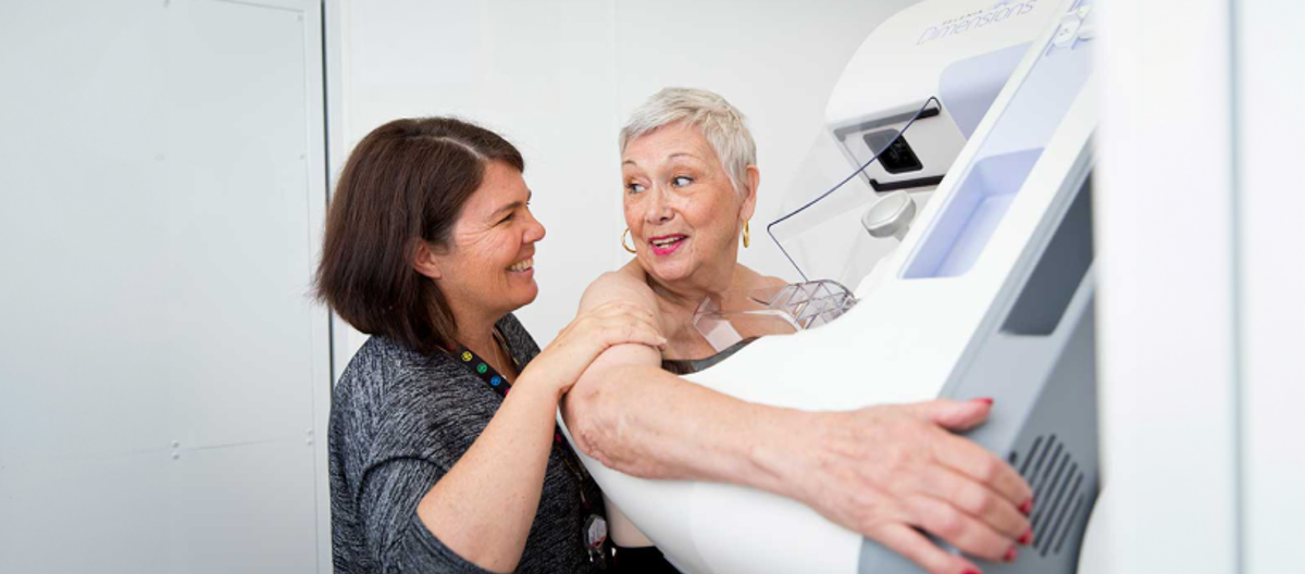 Radiographer screening a woman